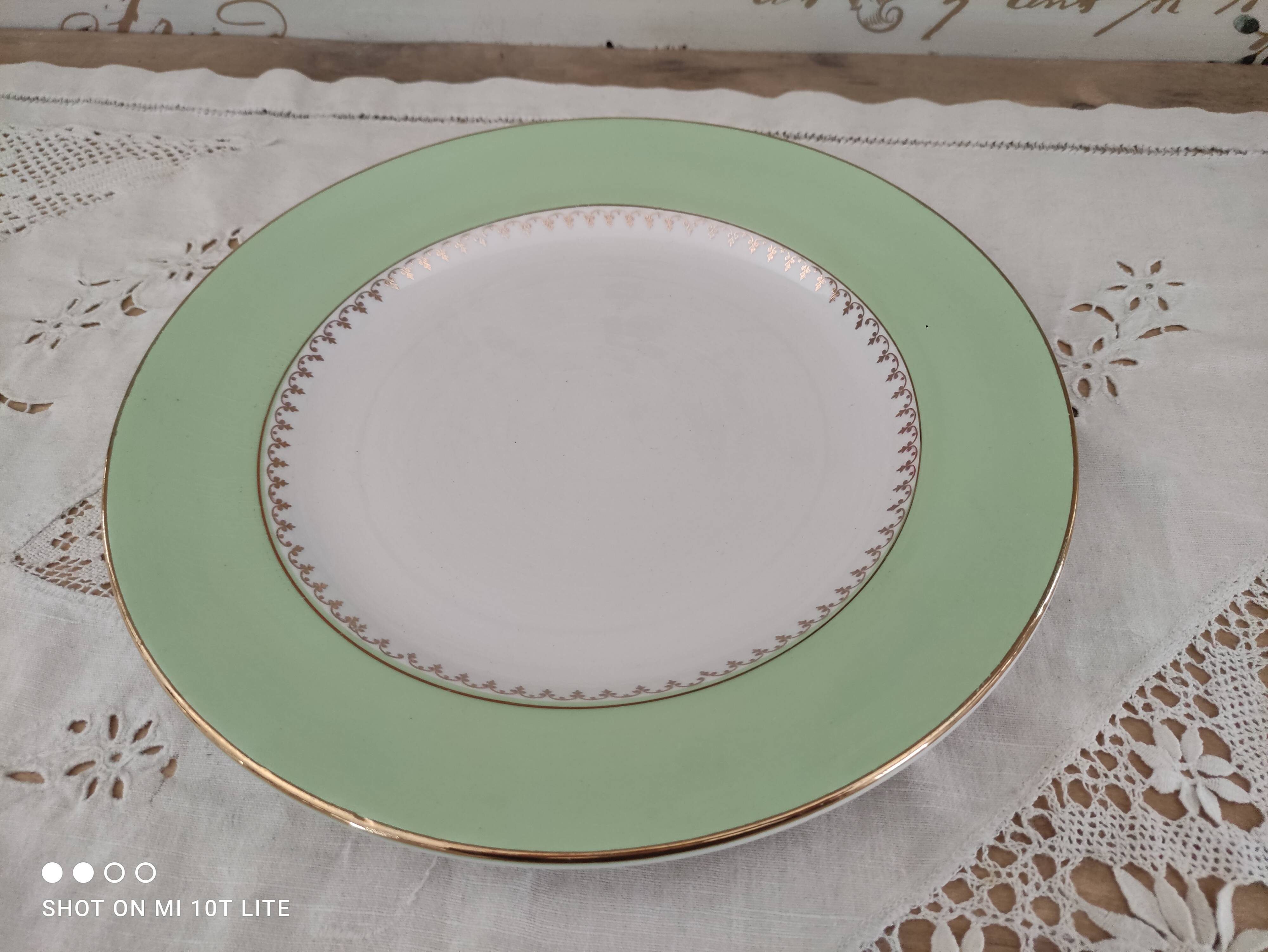 Round plate with aqua green rim and golden frieze, Cafés Lemaire.