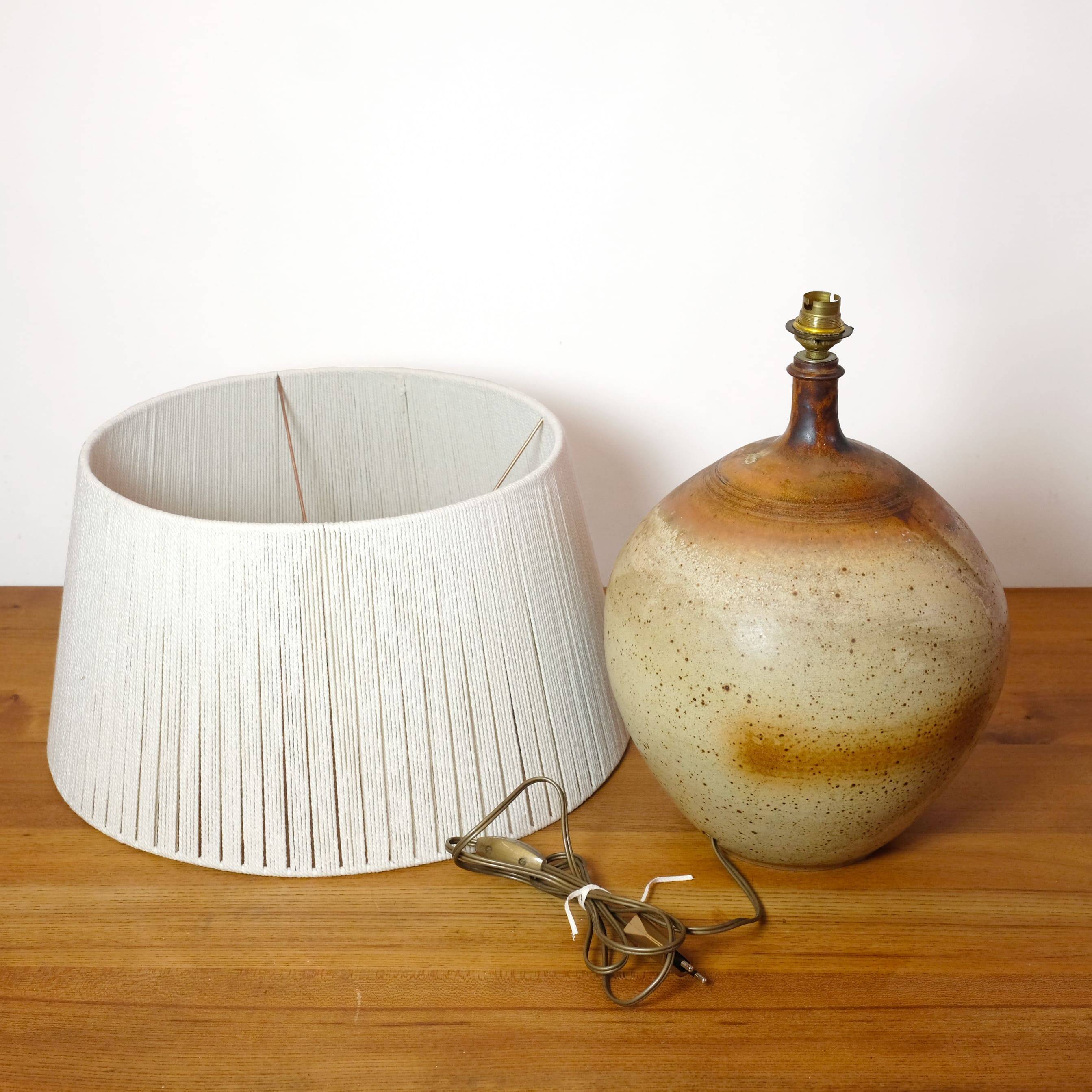 Large stone lamp with a cotton shade.