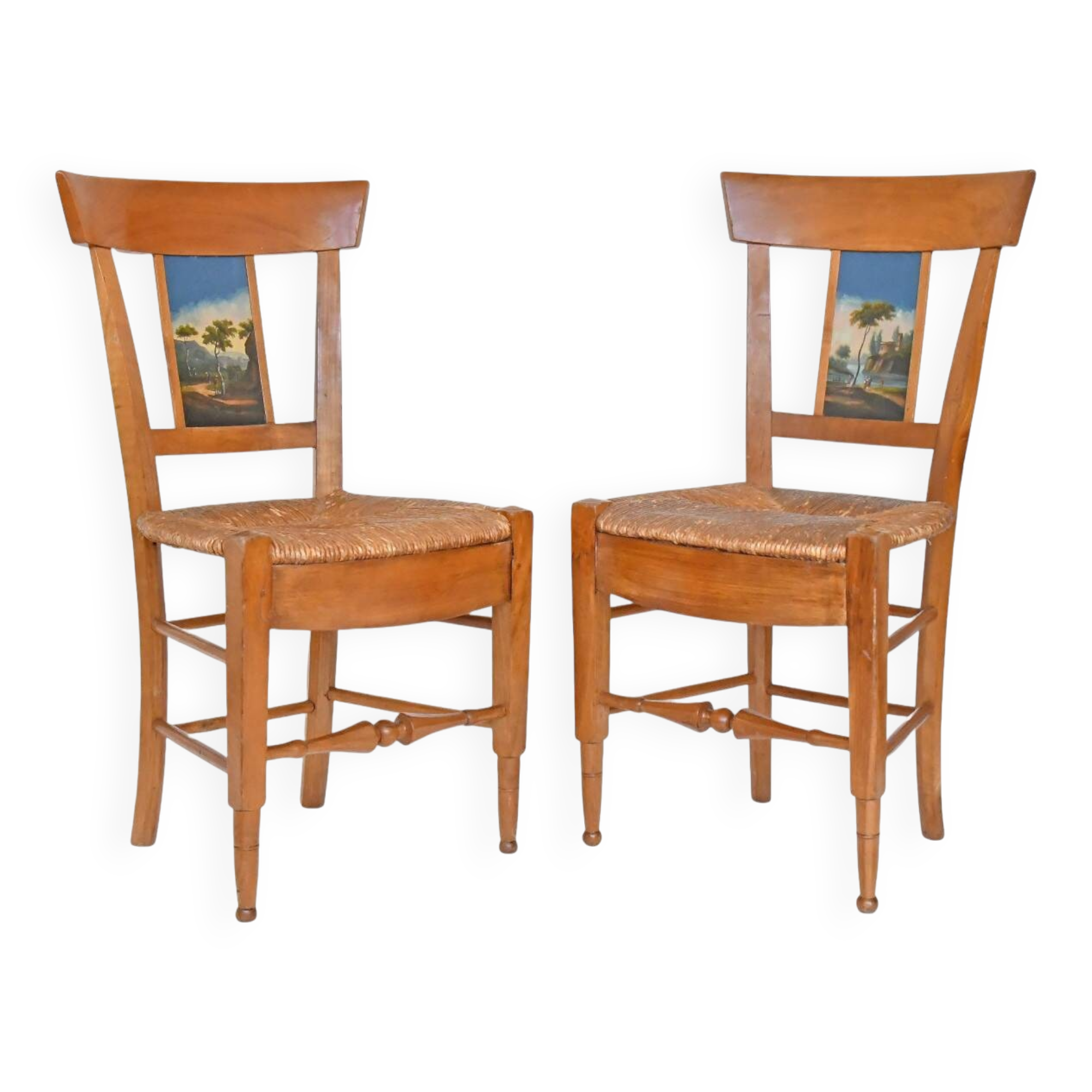 Pair of chairs with slatted backs and painted bands depicting animated landscapes.