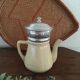 Old tea pot or coffee maker in faience cream with filter.