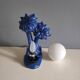 Blue ceramic palm lamp and white opaline globe