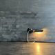 Old black metal and brass wall light, adjustable, 1930s.