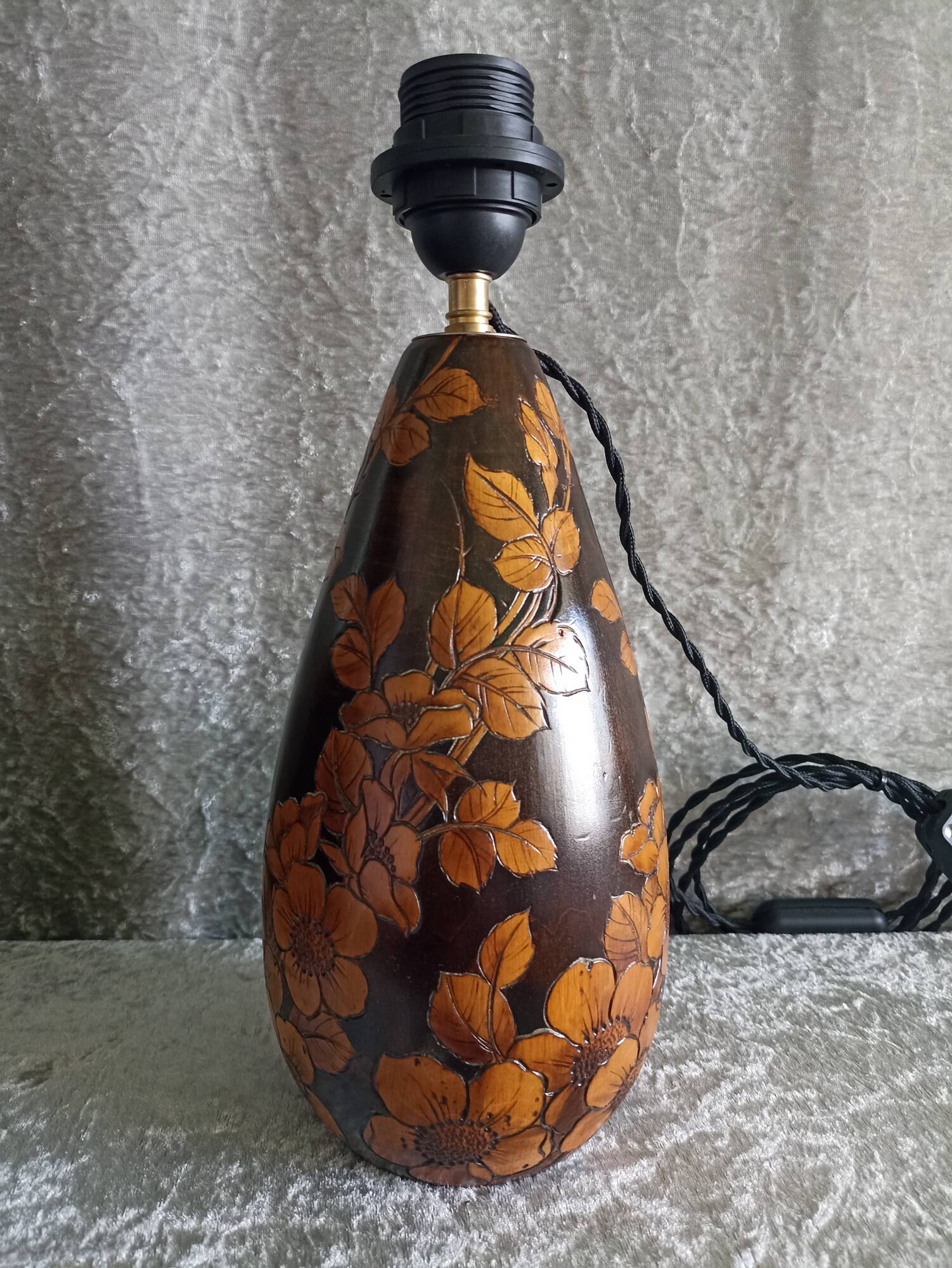 Carved wooden lamp with floral motif