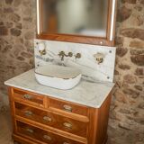 Antique washbasin cabinet from 1928 in wood and marble with a lighted mirror.
