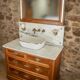 Meuble sous vasque ancien de 1928 en bois et marbre avec miroir éclairant