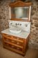Antique washbasin cabinet from 1928 in wood and marble with illuminating mirror.