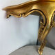 Small corner console in resin with a gold finish.