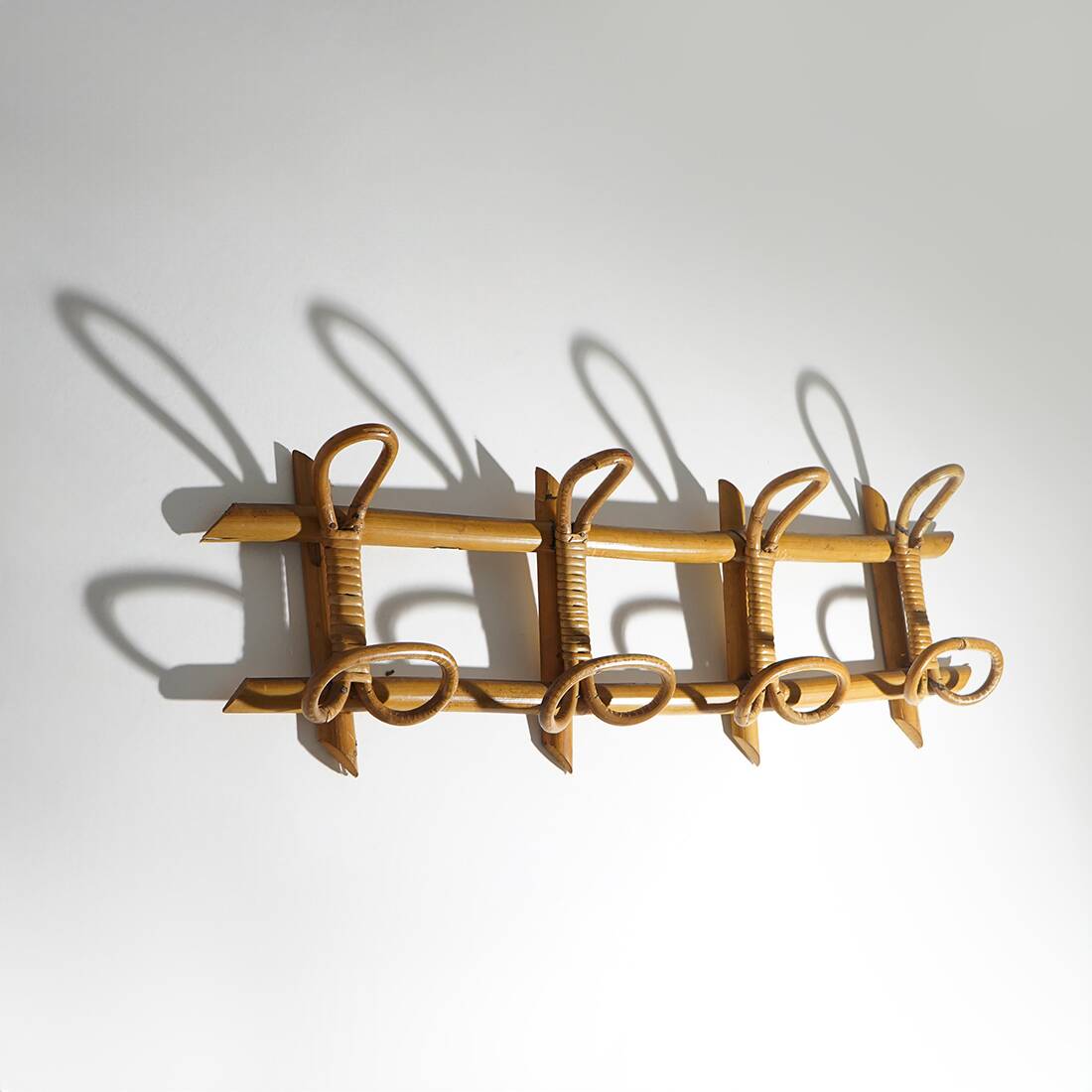 Wall coat rack in rattan and woven wicker, 1960s.