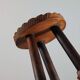Vintage three-legged wooden milk stool in brutalist style with sculpted decoration.