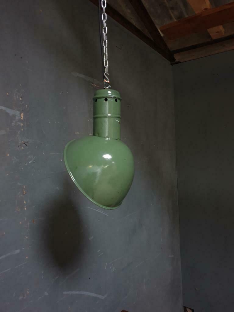 Old industrial enamel lamp in green