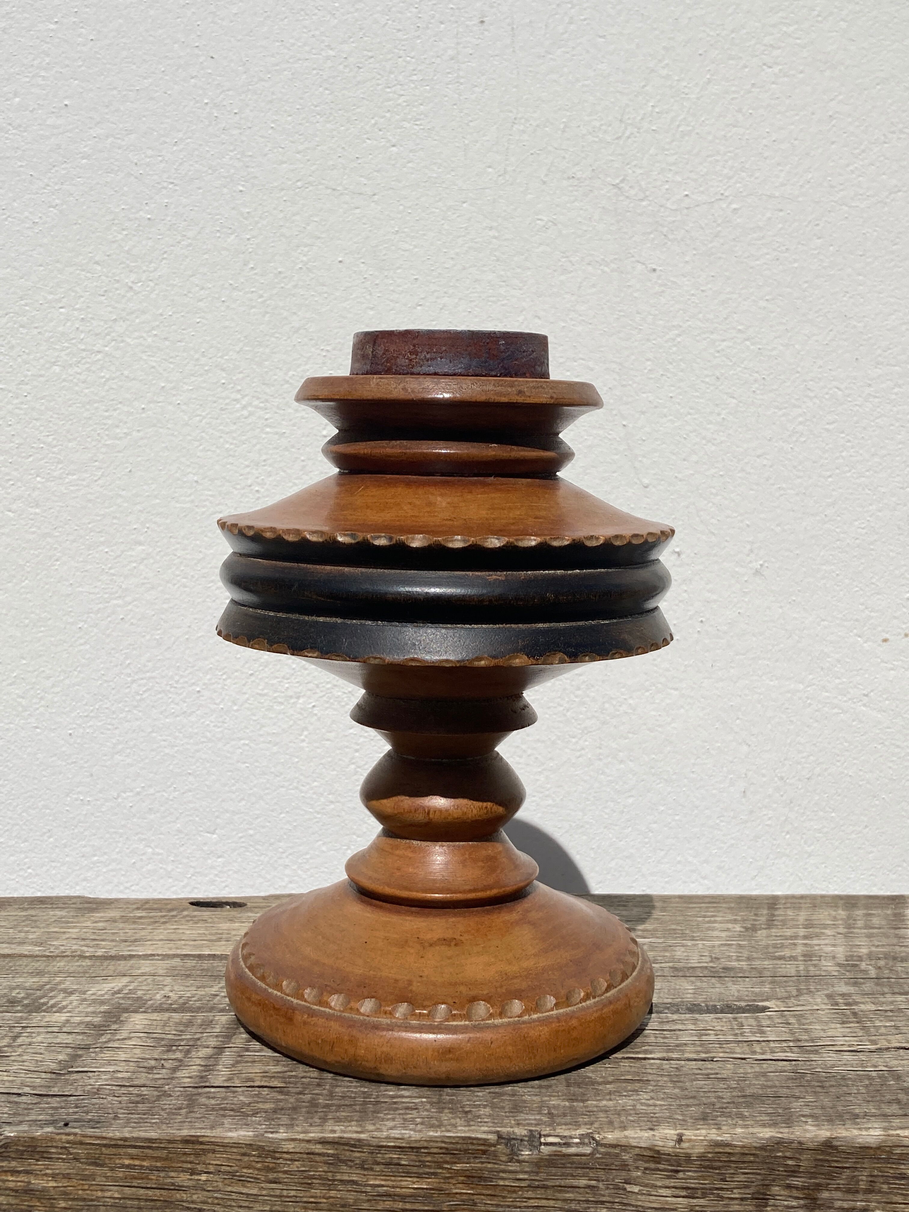 Foot of turned wooden lamp and carved