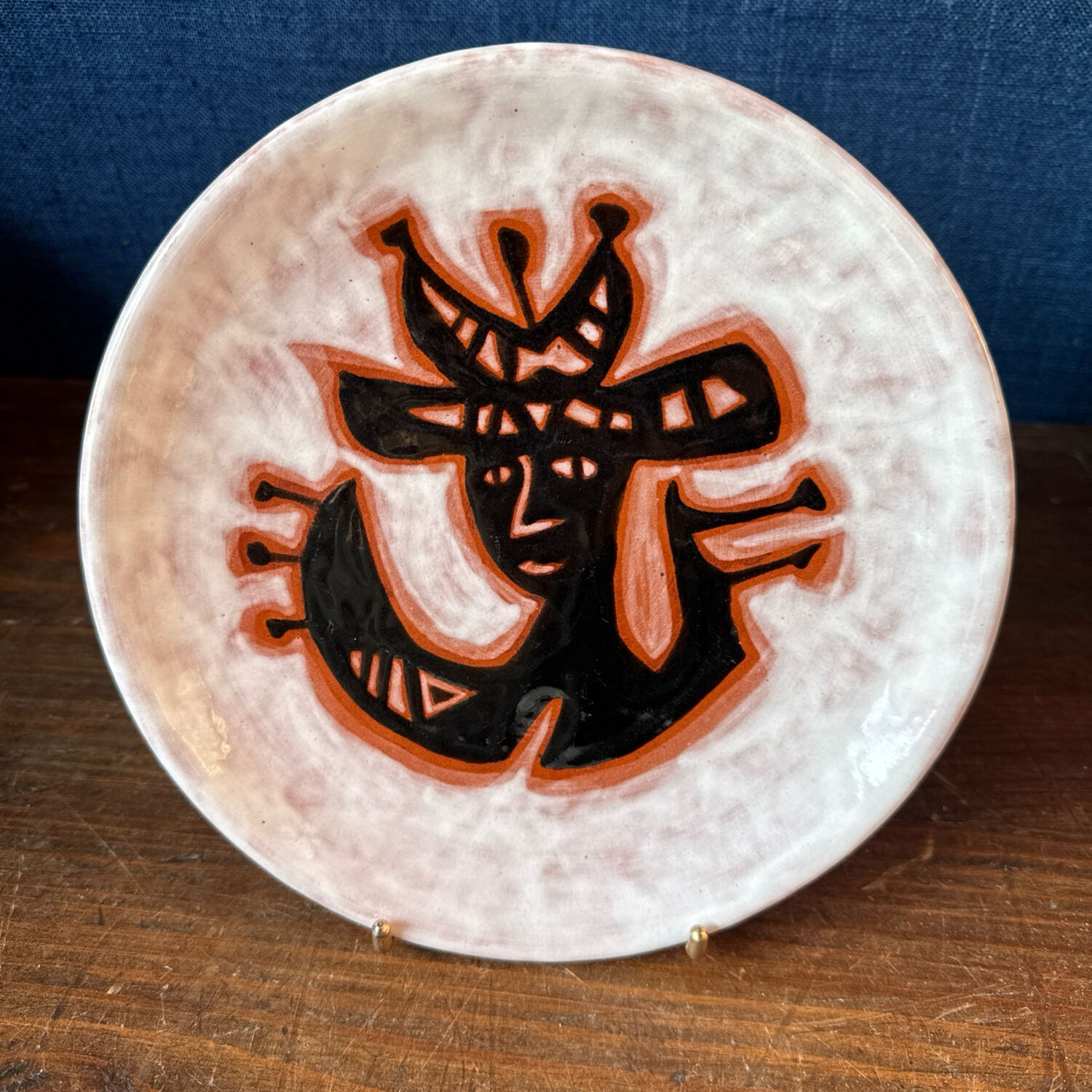 Terracotta plate, Jean Lurçat decorated with a character on a white background.