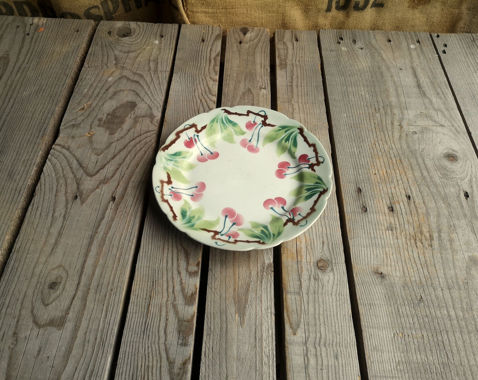 Old decorative plate in barbotine by luneville cherry motif