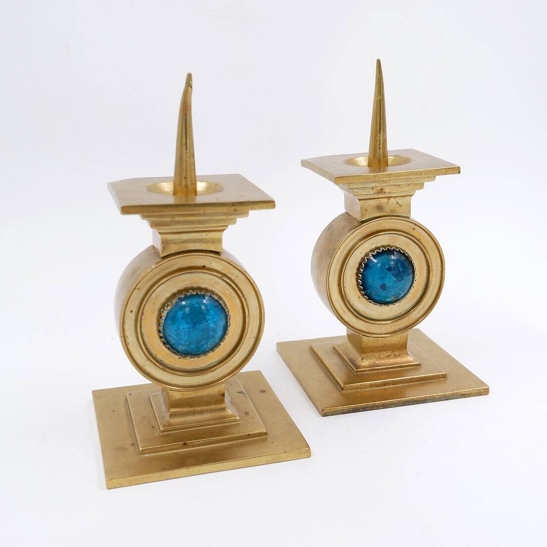 Pair of brass candlesticks decorated with a blue stone inlaid in the center