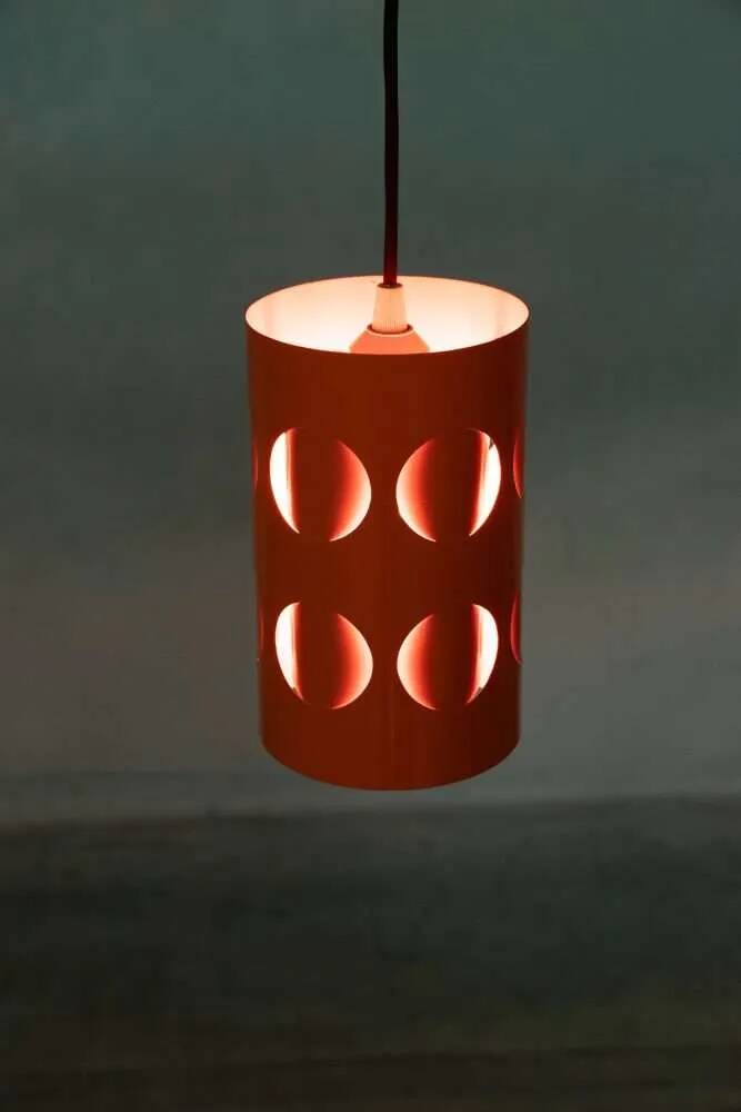 Vintage orange suspension light in a 1970s space age style.