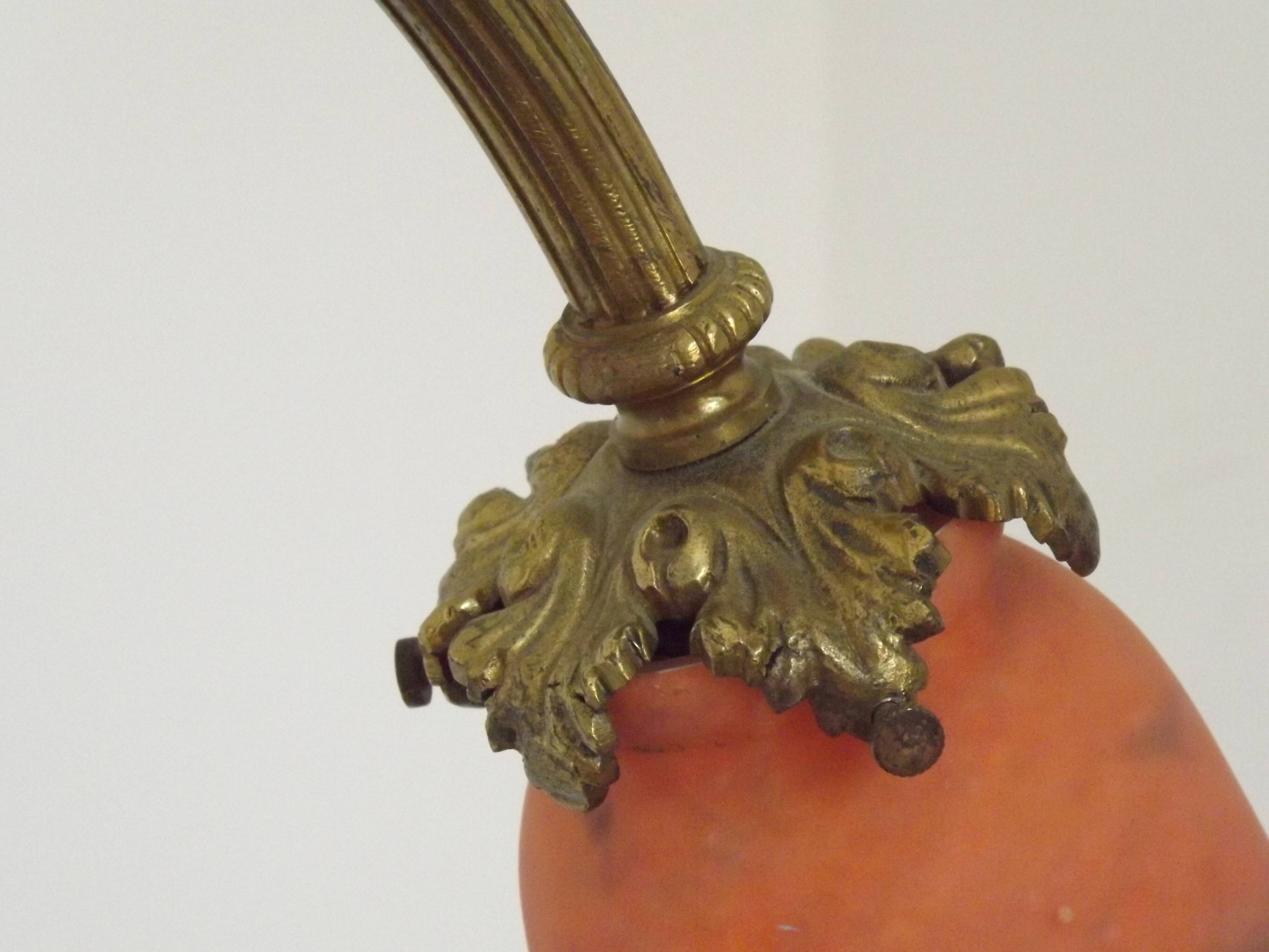 Art Nouveau three-light chandelier in bronze with orange and green glass shade, France.