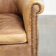 Vintage cowhide club armchair in English style in a light colour scheme