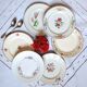 Antique dessert plates mismatched in earthenware with gilded edges