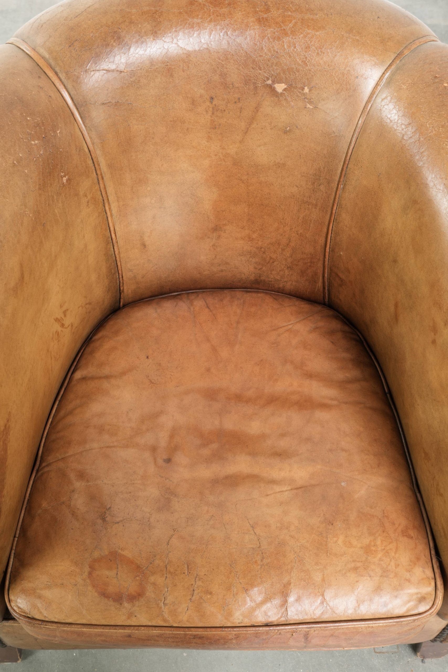 Vintage sheepskin club armchair finished with decorative nails