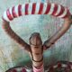 Bottle holder in braided wicker, rattan and scoubidou