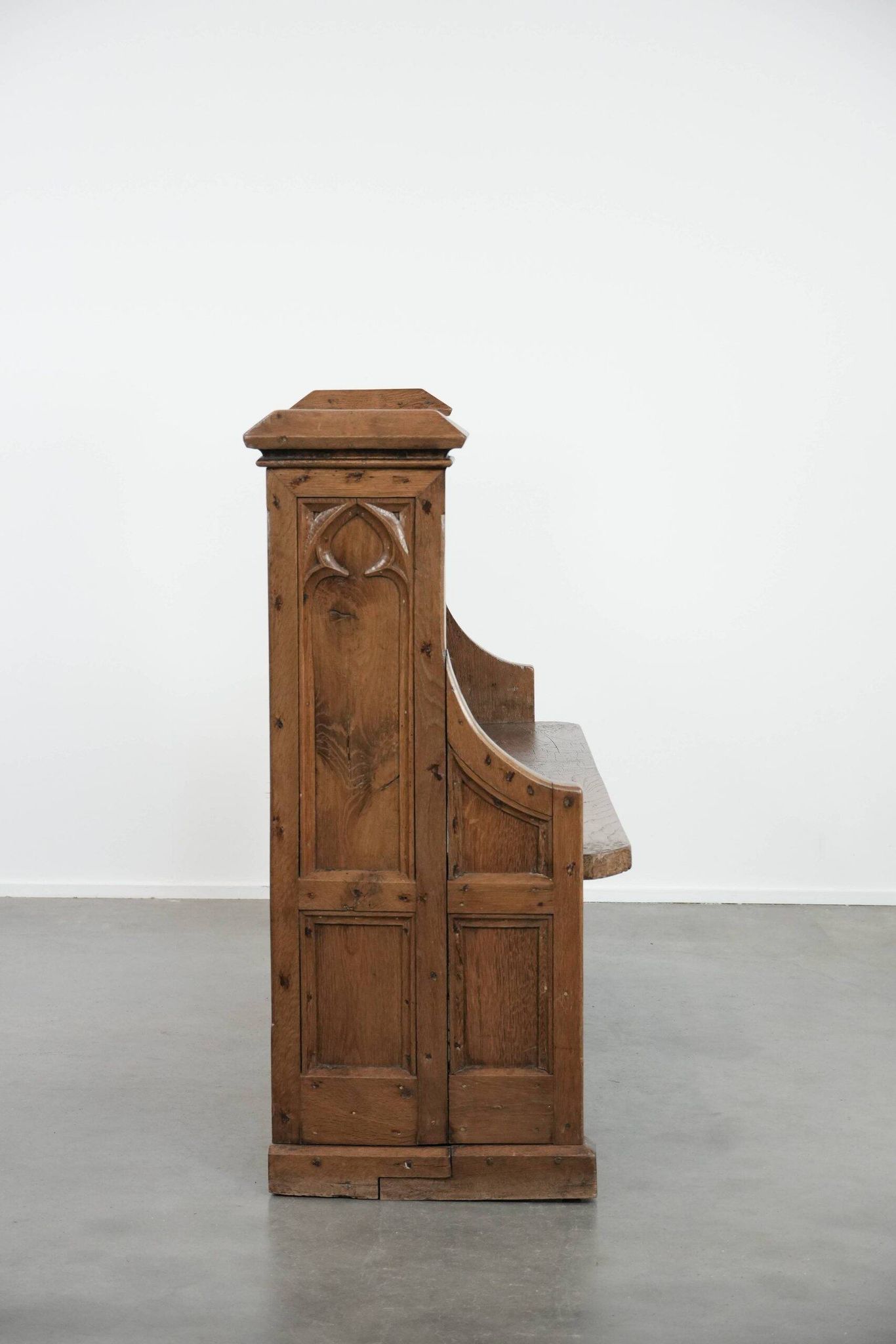 Antique oak church bench in Gothic style with beautiful wood carving