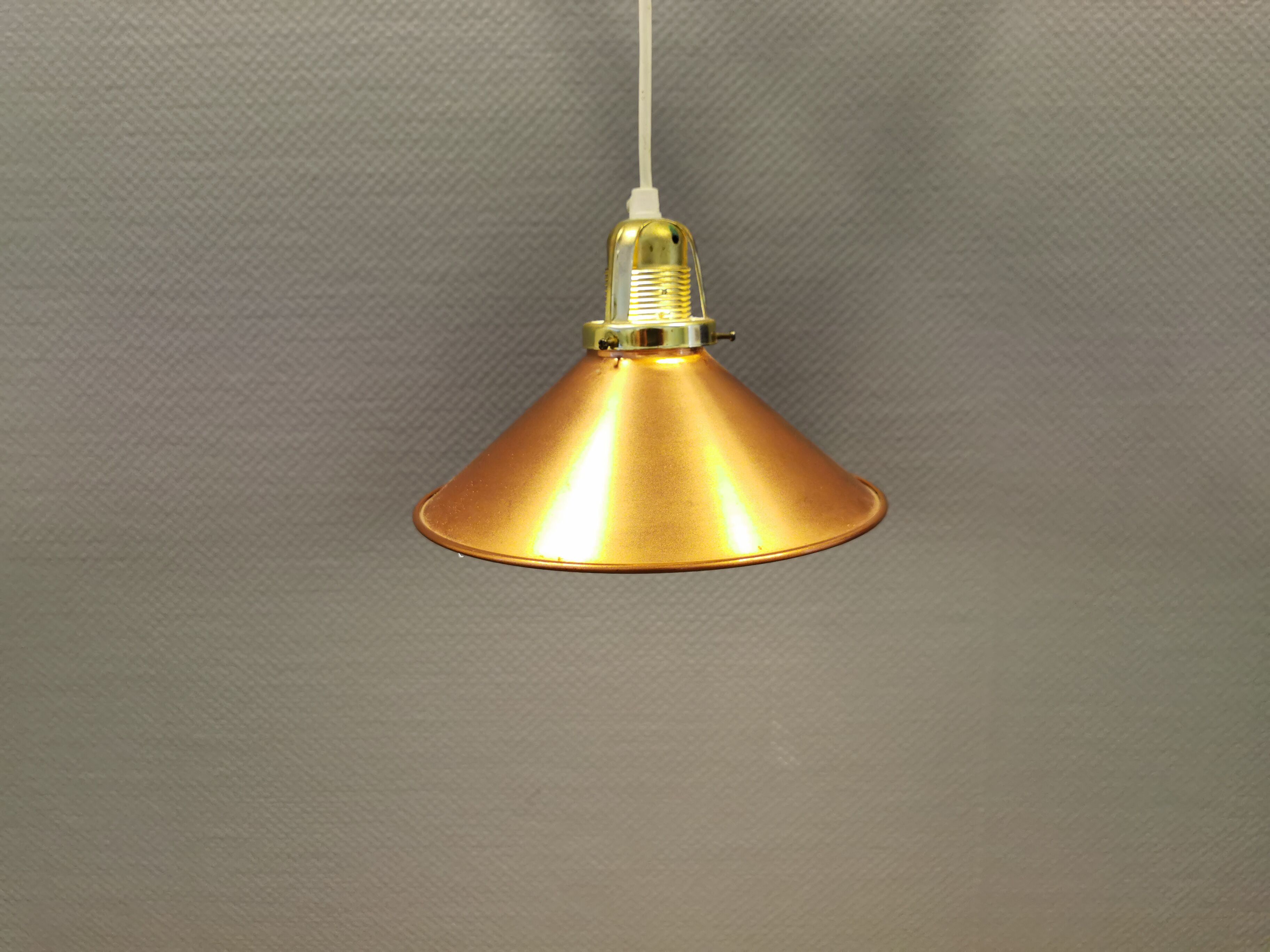 Copper hanging lamp with brass colored top and white inside lacquer.