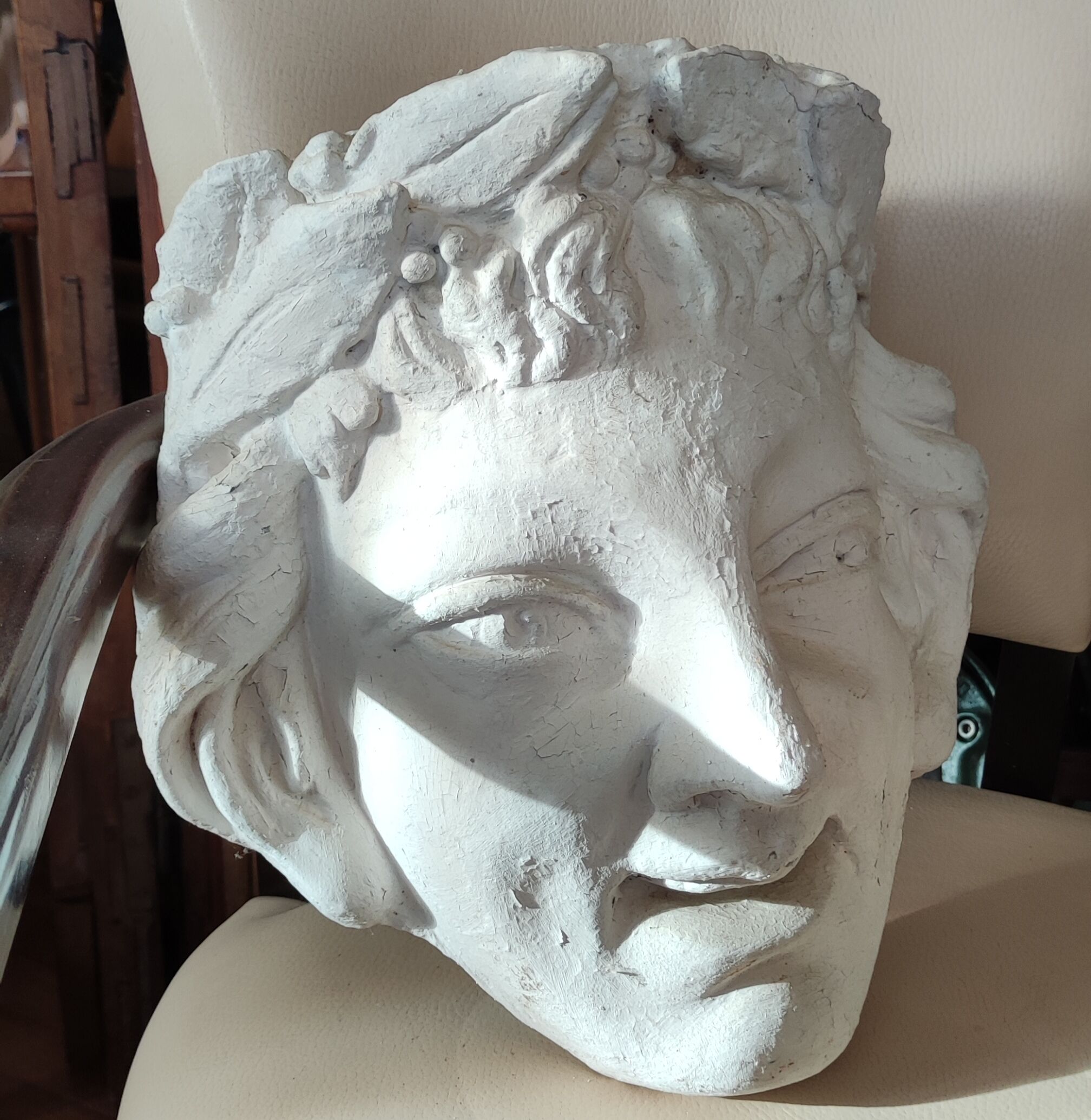 Old face in plaster antique decoration