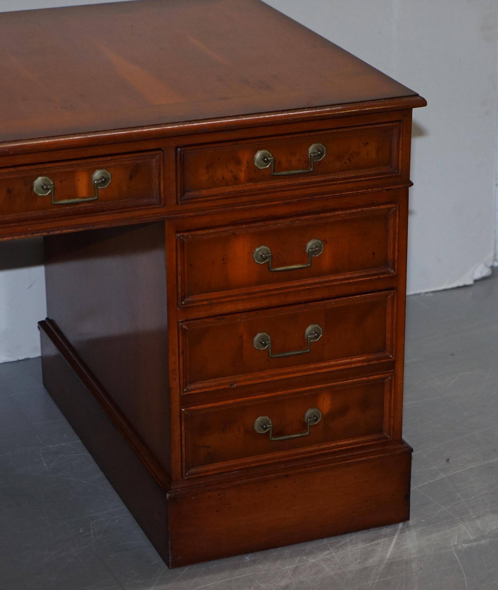 Partner desk with double pedestal in burr yew wood with decorated top.
