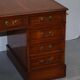 Partner desk with double pedestal in burr yew wood with decorated top.