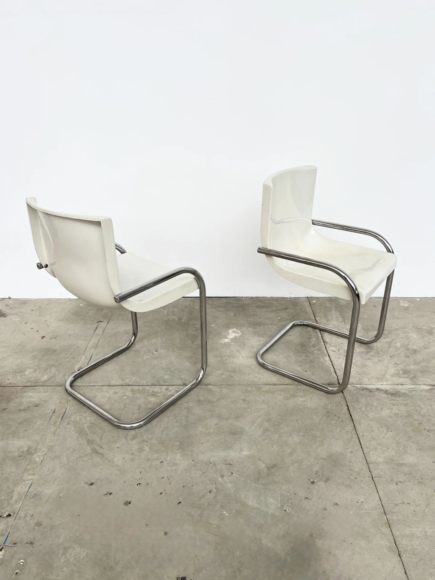 Pair of white moulded shell chairs with chrome tube — Space Age 70s