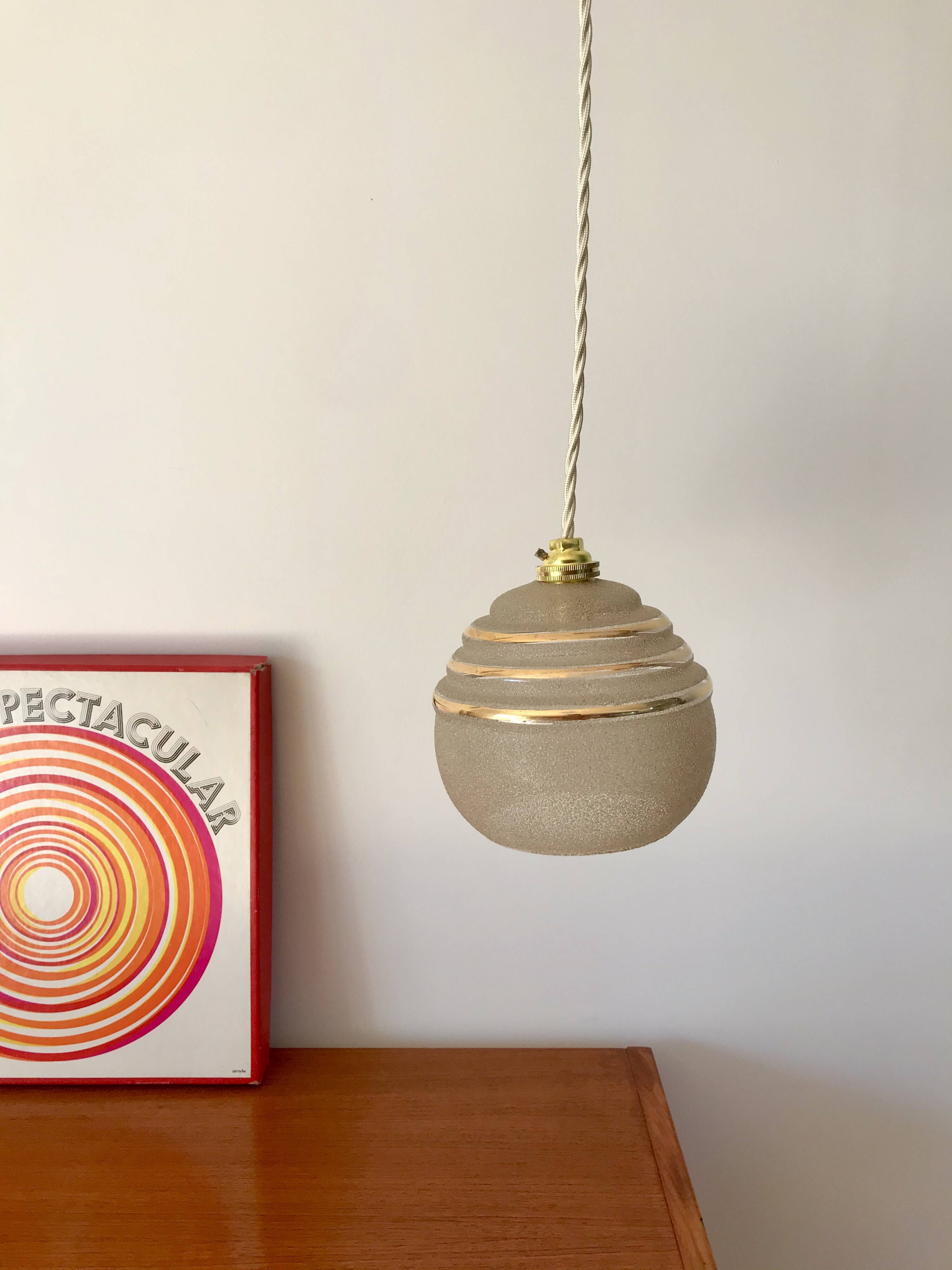 ball pendant light in white granite glass and gold edging from the 1950s