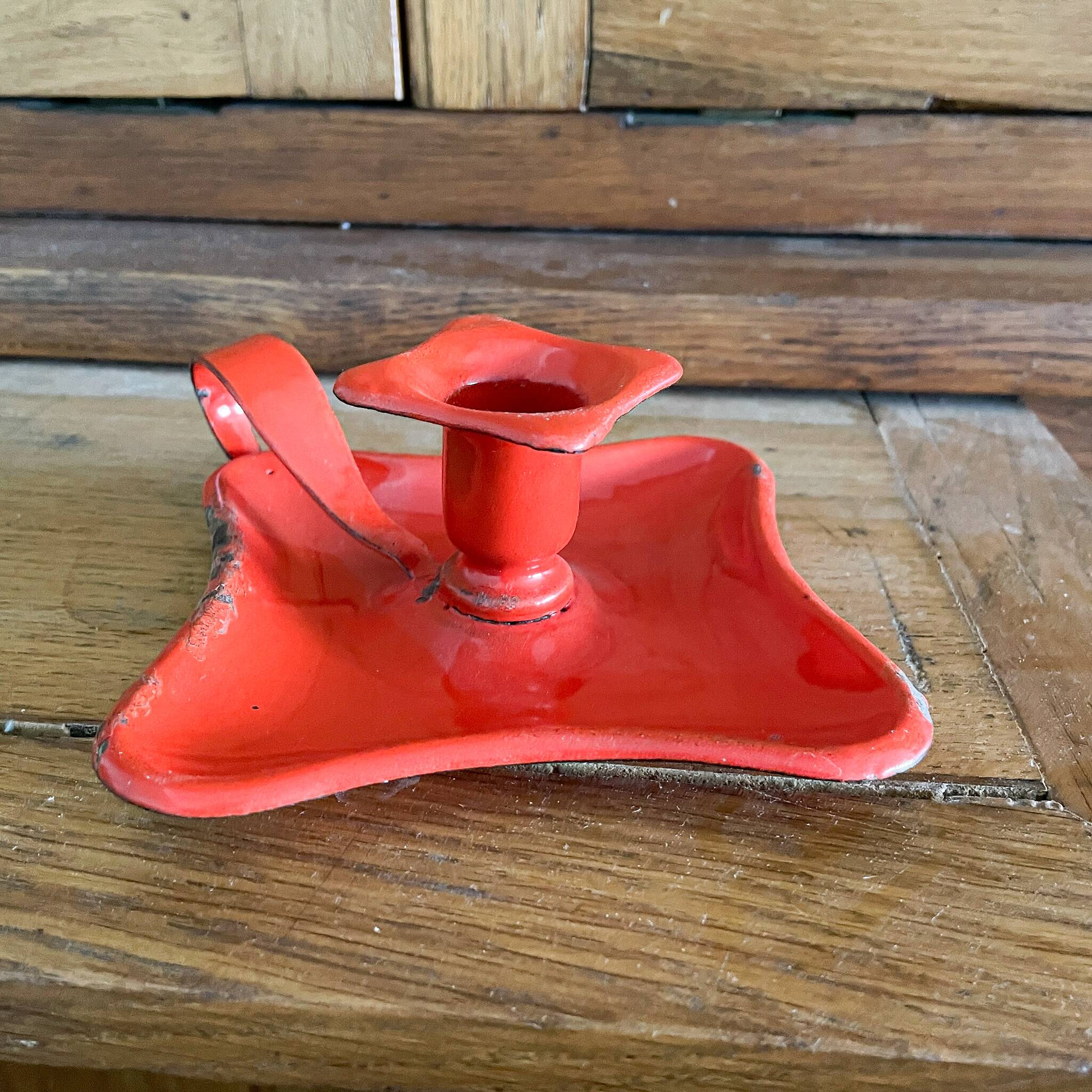 Red enamelled sheet metal candle holder