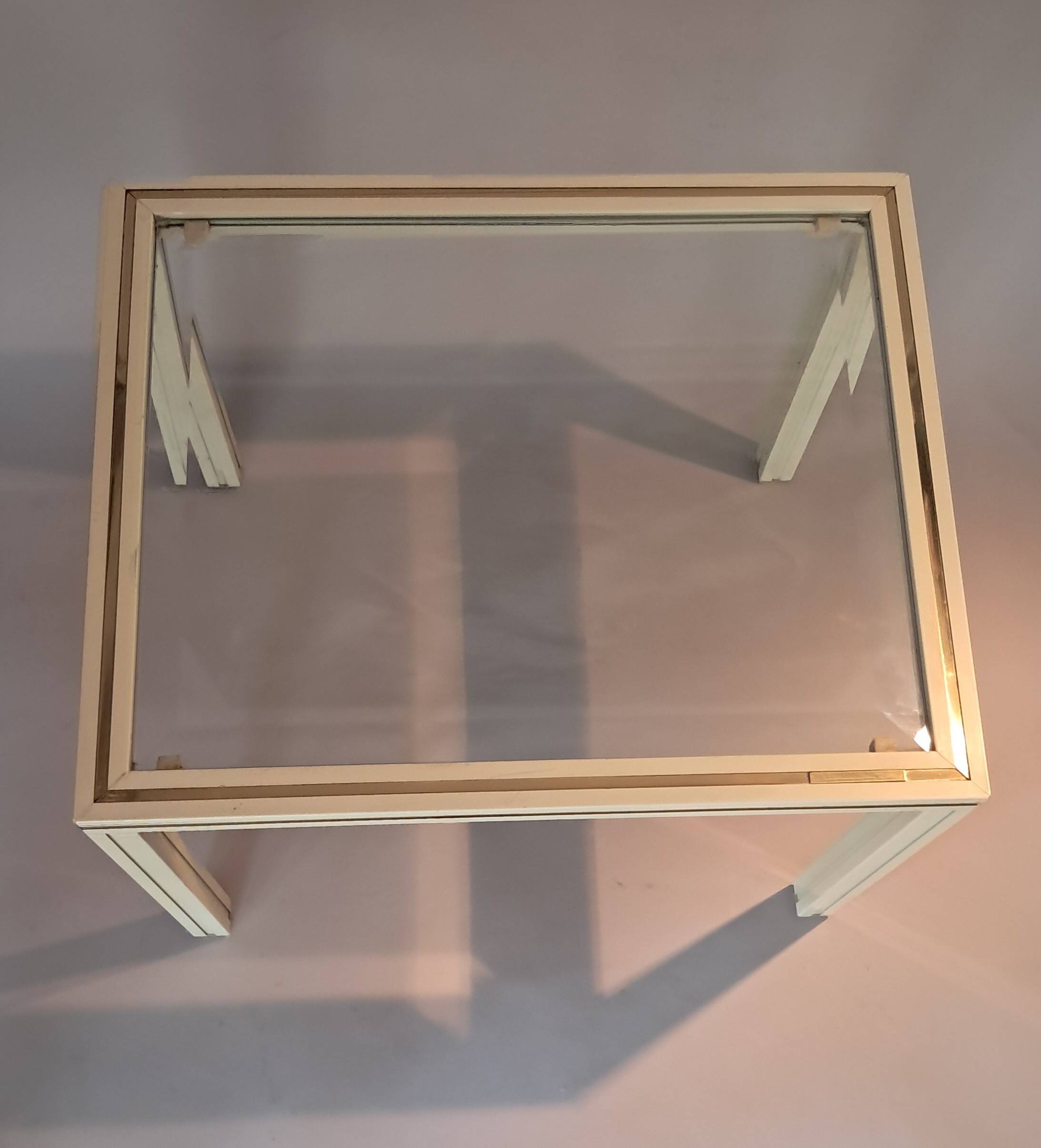 White lacquered side table by Pierre Vandel with gold brass.