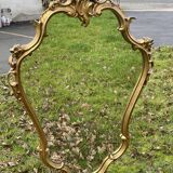 Louis XV Style wood and gilded stucco mirror with animated shape