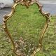 Louis XV Style wood and gilded stucco mirror with animated shape