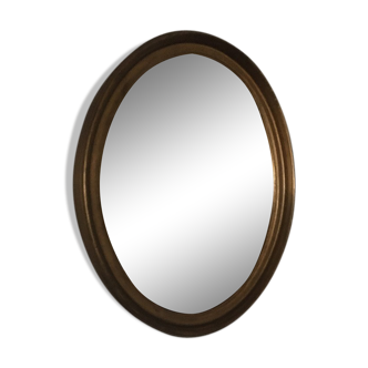 Oval mirror in gilded wood