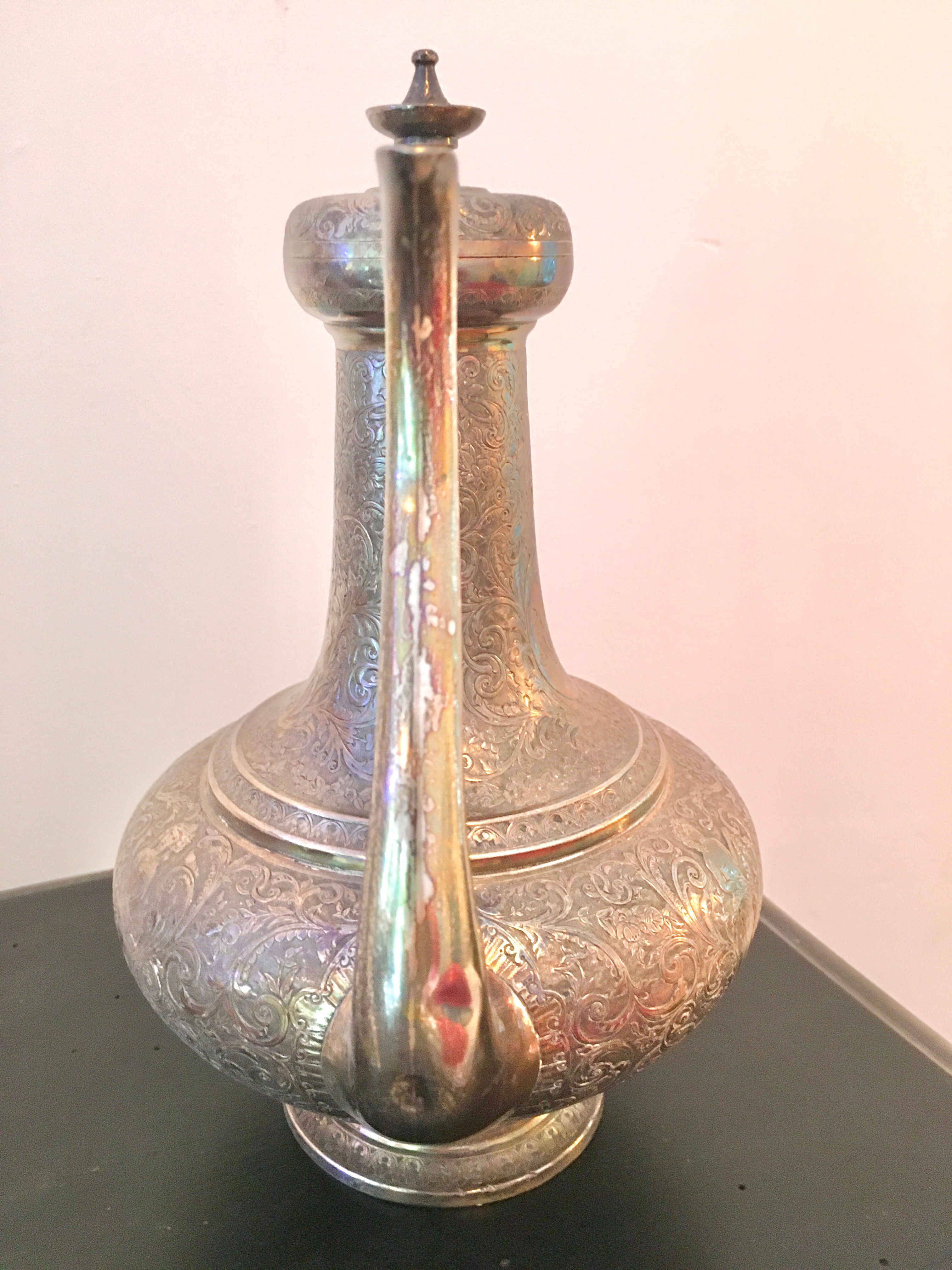 Oriental teapot made of crafted silver metal