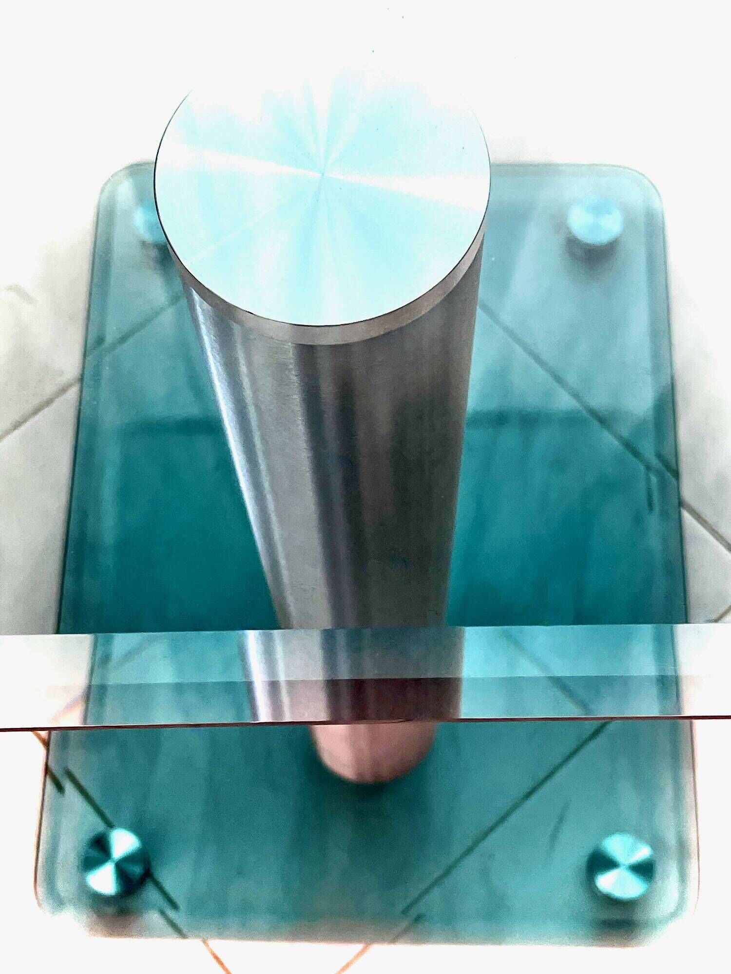 Contemporary square side table in glass with a metallic central column.