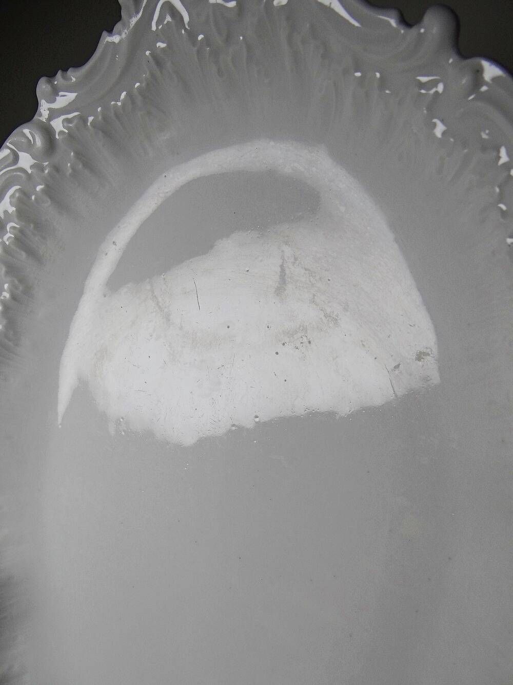Antique deep dish in white Limoges porcelain, with rockwork relief.