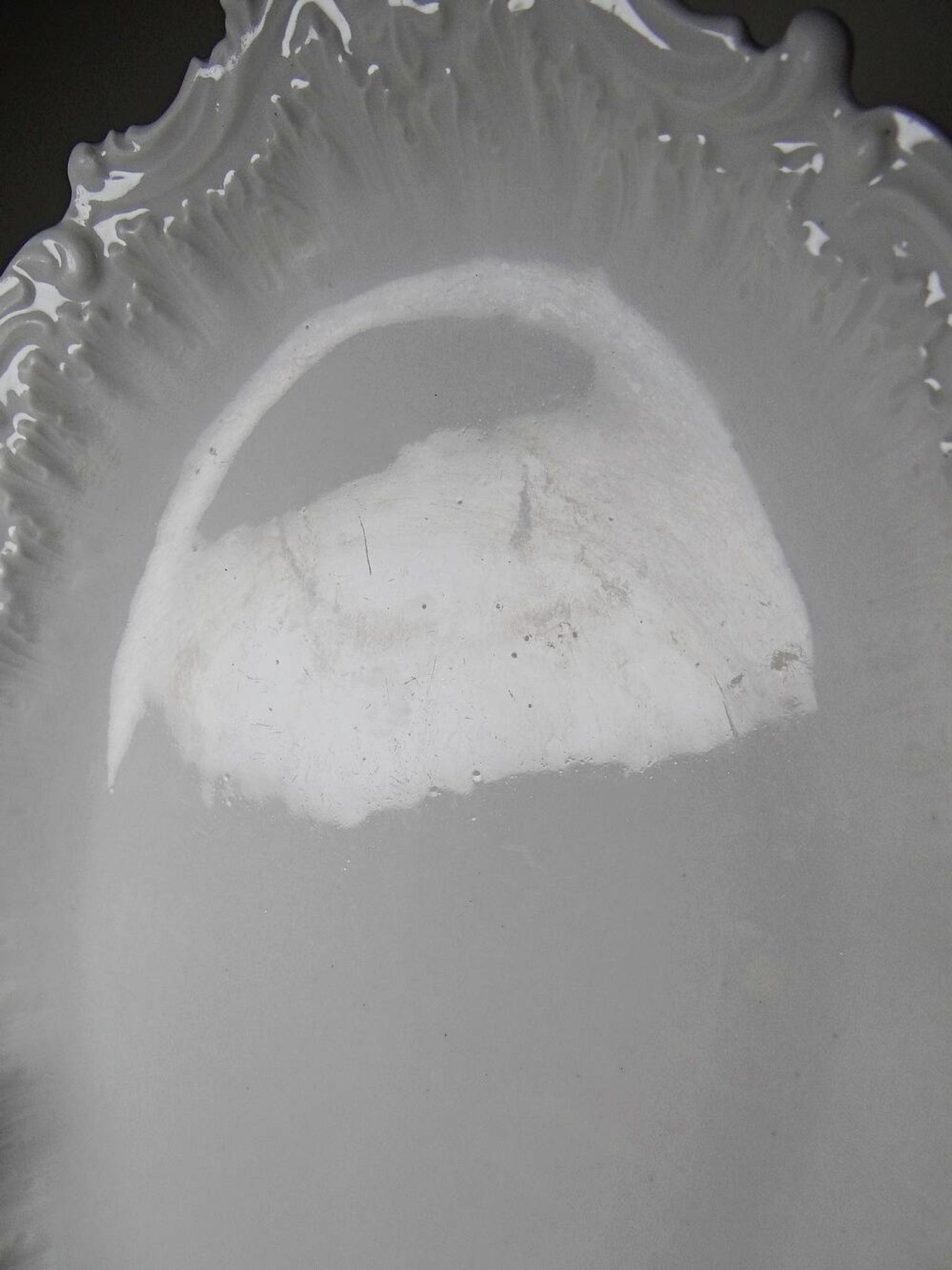 Antique deep dish in white Limoges porcelain, with rockwork relief.