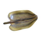 Wooden top in the shape of a leaf