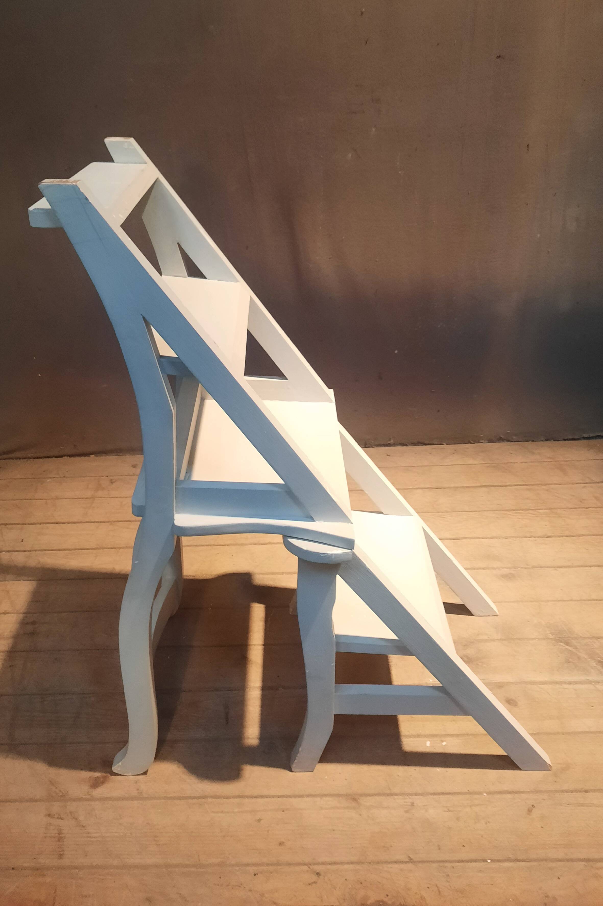 White chair convertible into a staircase.