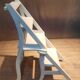White chair convertible into a staircase.