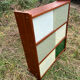 Vintage 1960s display shelf with sliding glass doors.