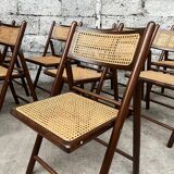 Serie de 8 chaises pliantes vintage en bois et cannage 1960