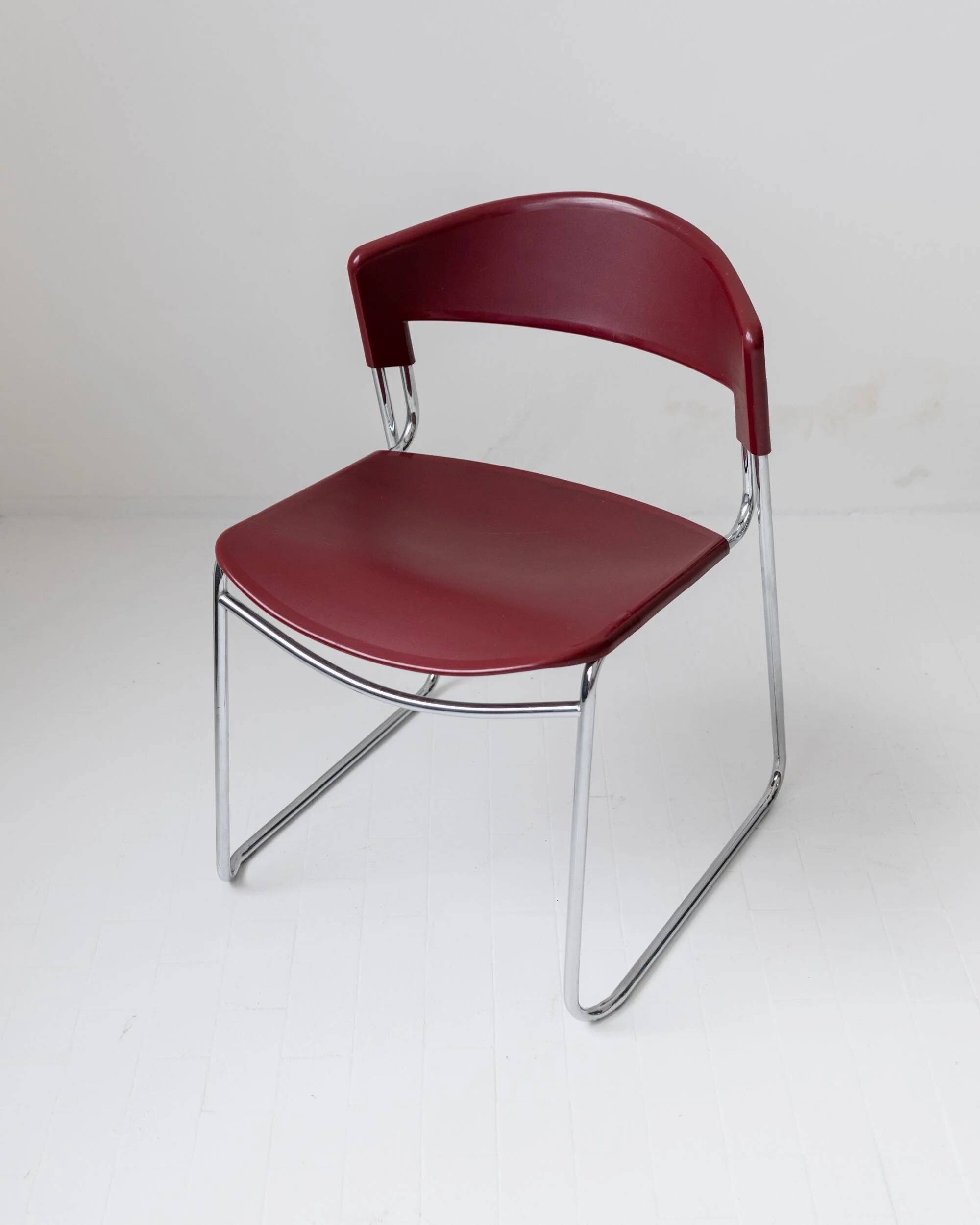 Vintage dining chair from the 1980s by Paolo Favaretto for Assisa, stackable, design Italy 1986 - chrome and red plastic - a classic of design.
