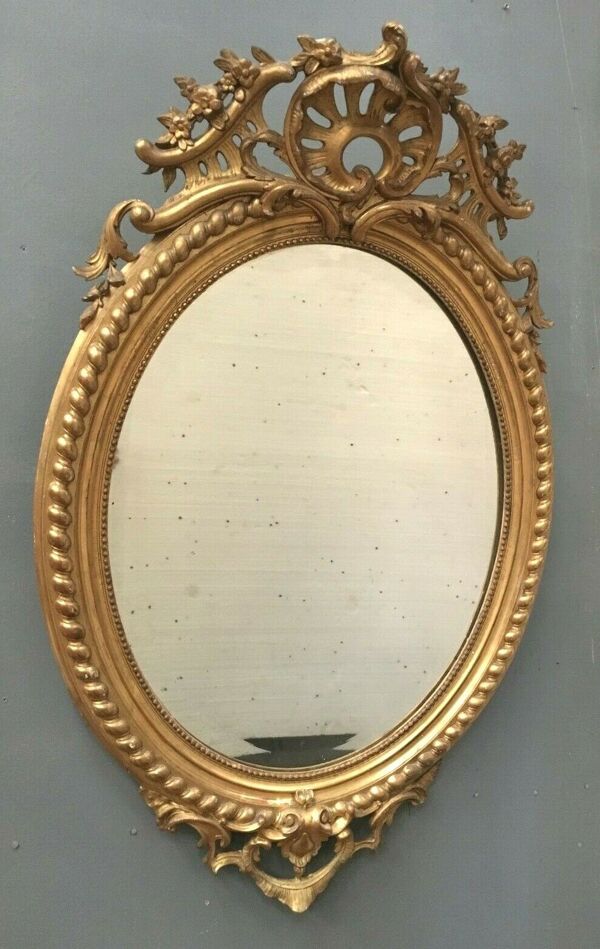 Miroir ovale a fronton en bois et stuc doré Glace ovale biseautée Napoléon III - 80x120cm