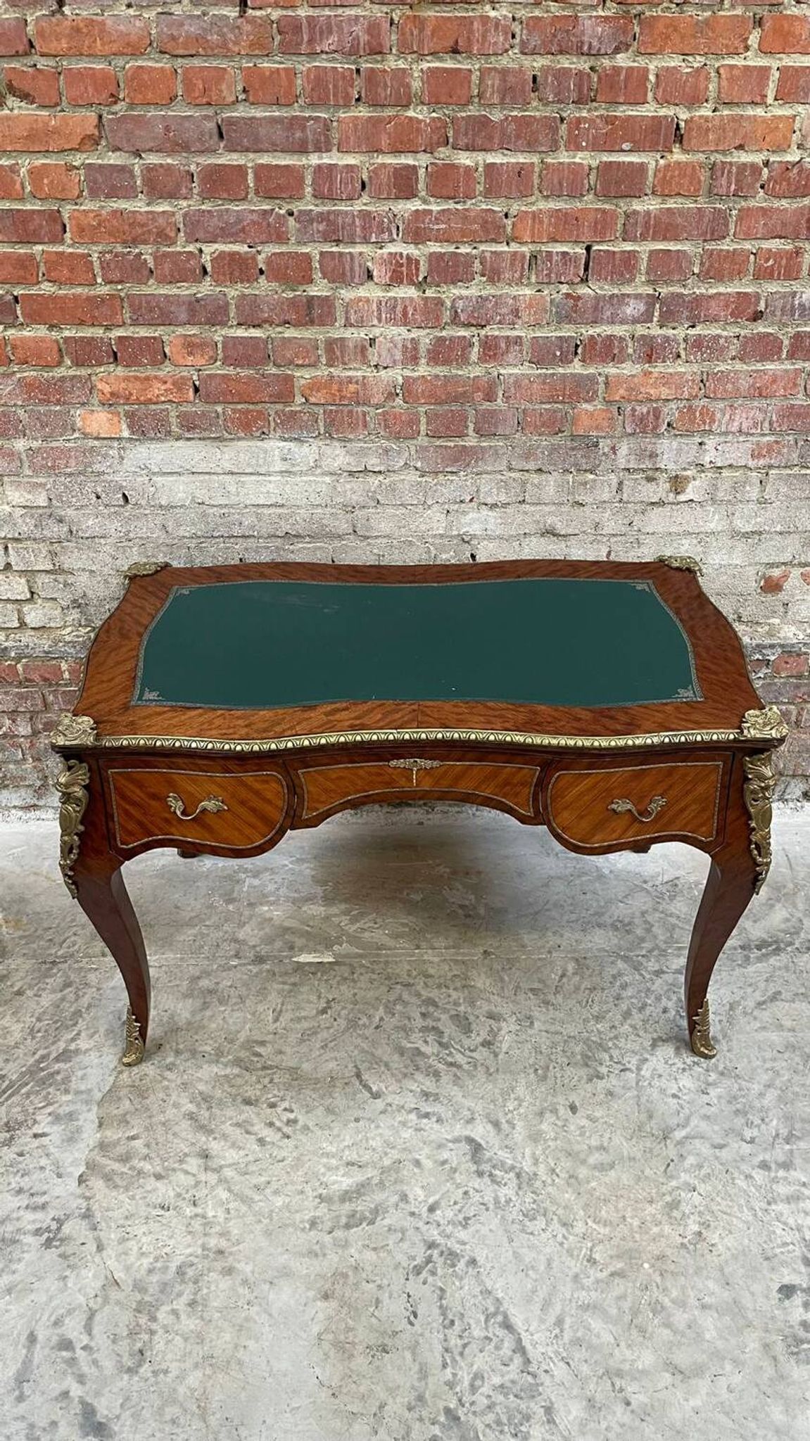 Antique French-style desk with green leather top and bronze mounts