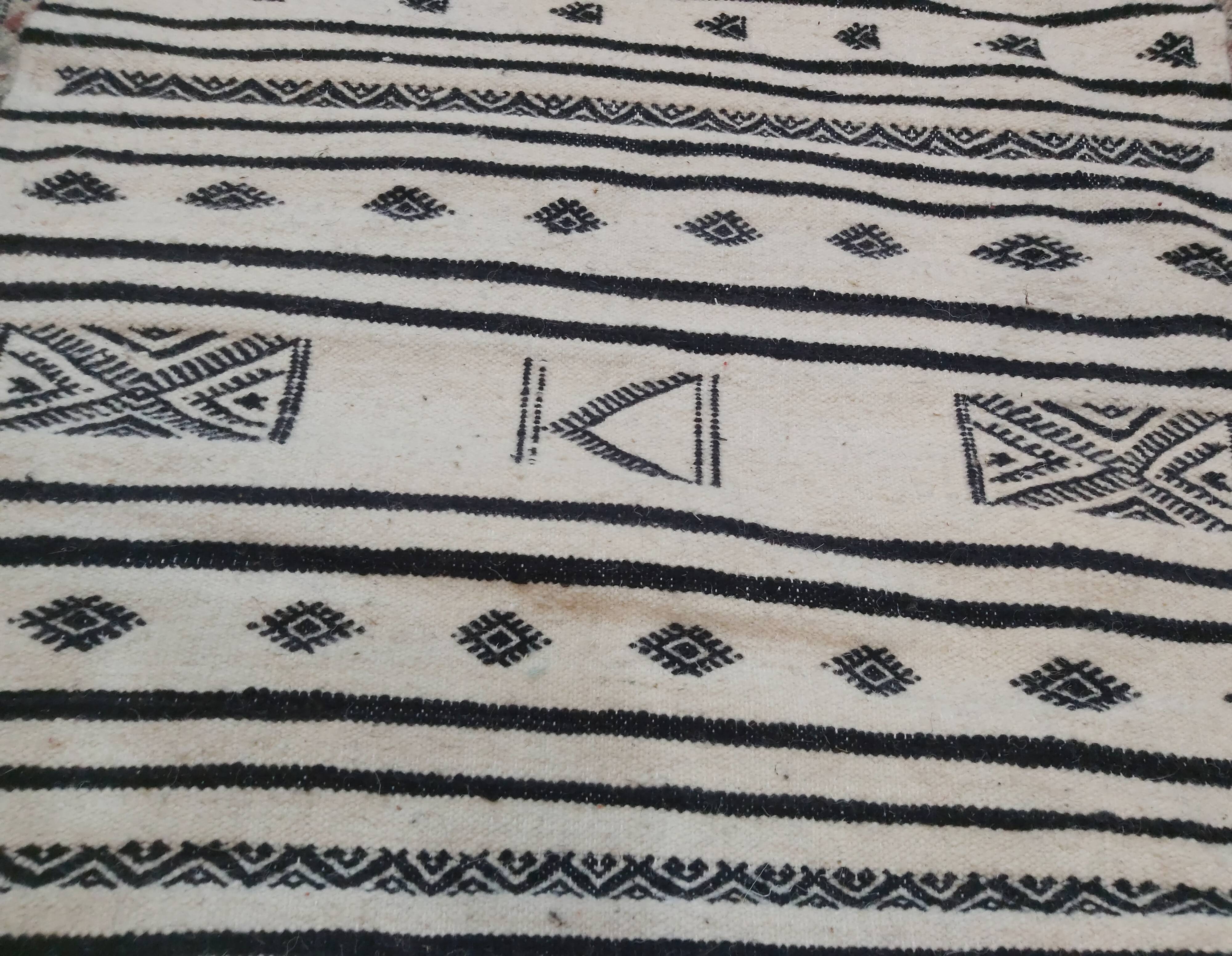 Traditional handmade white and black kilim carpet
