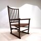Fauteuil Manou en rotin et assise en cuir, 1960